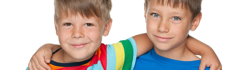 Best friends: two young boys arm in arm, smling